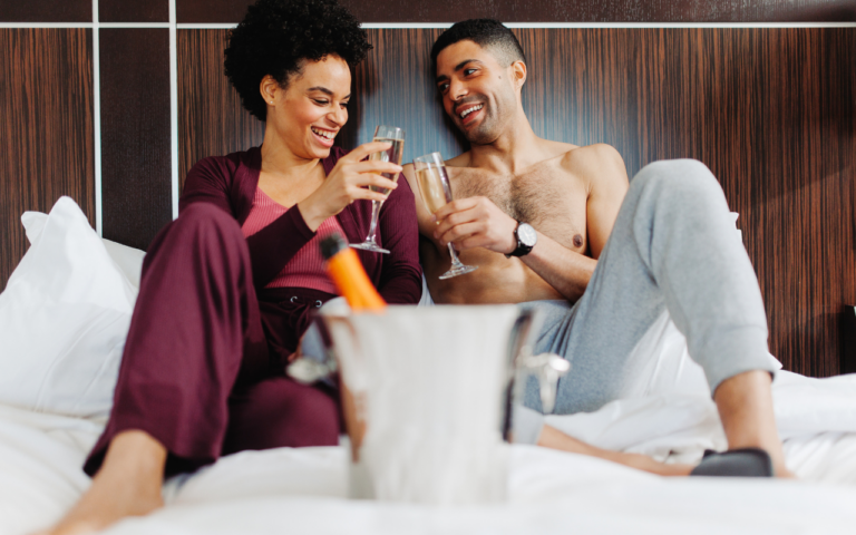A couple enjoying drinks in room.