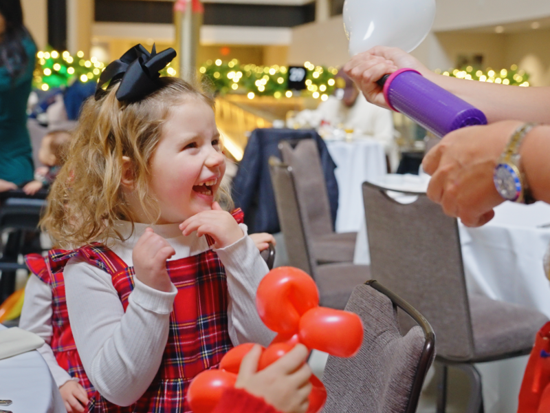 A child enjoying balloon animals.